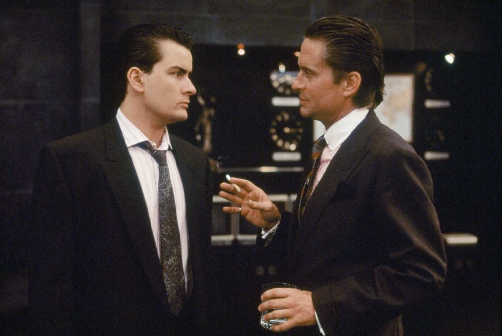 FILE - In this 1987 file film publicity image originally released by 20th Century Fox, Charlie Sheen, left, and Michael Douglas are shown in a scene from "Wall Street." (AP Photo/20th Century Fox, File) NO SALES